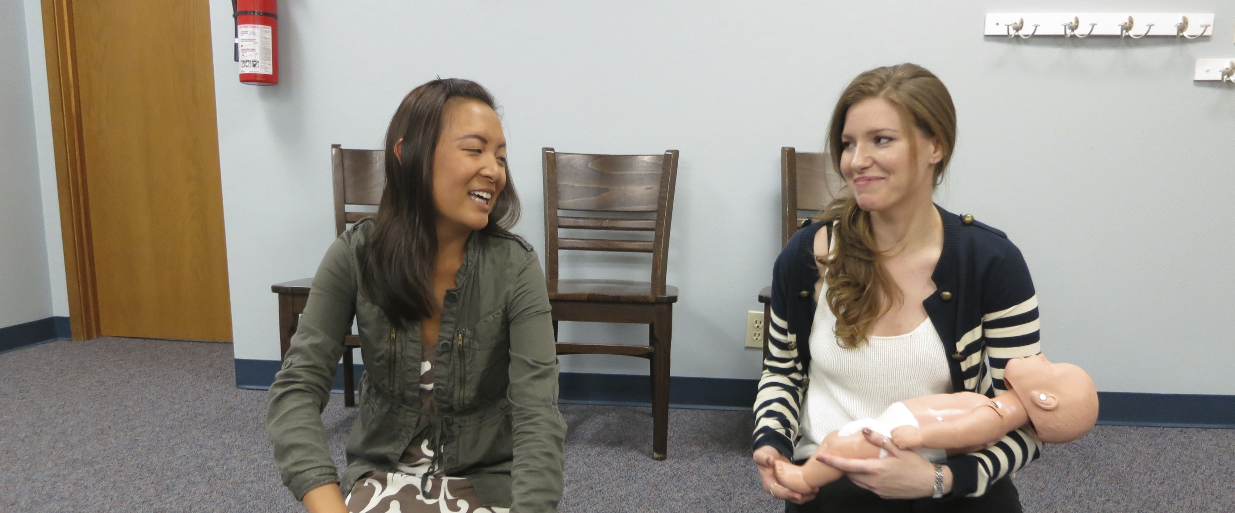 Instructor leading CPR training with manikin in Seattle classroom