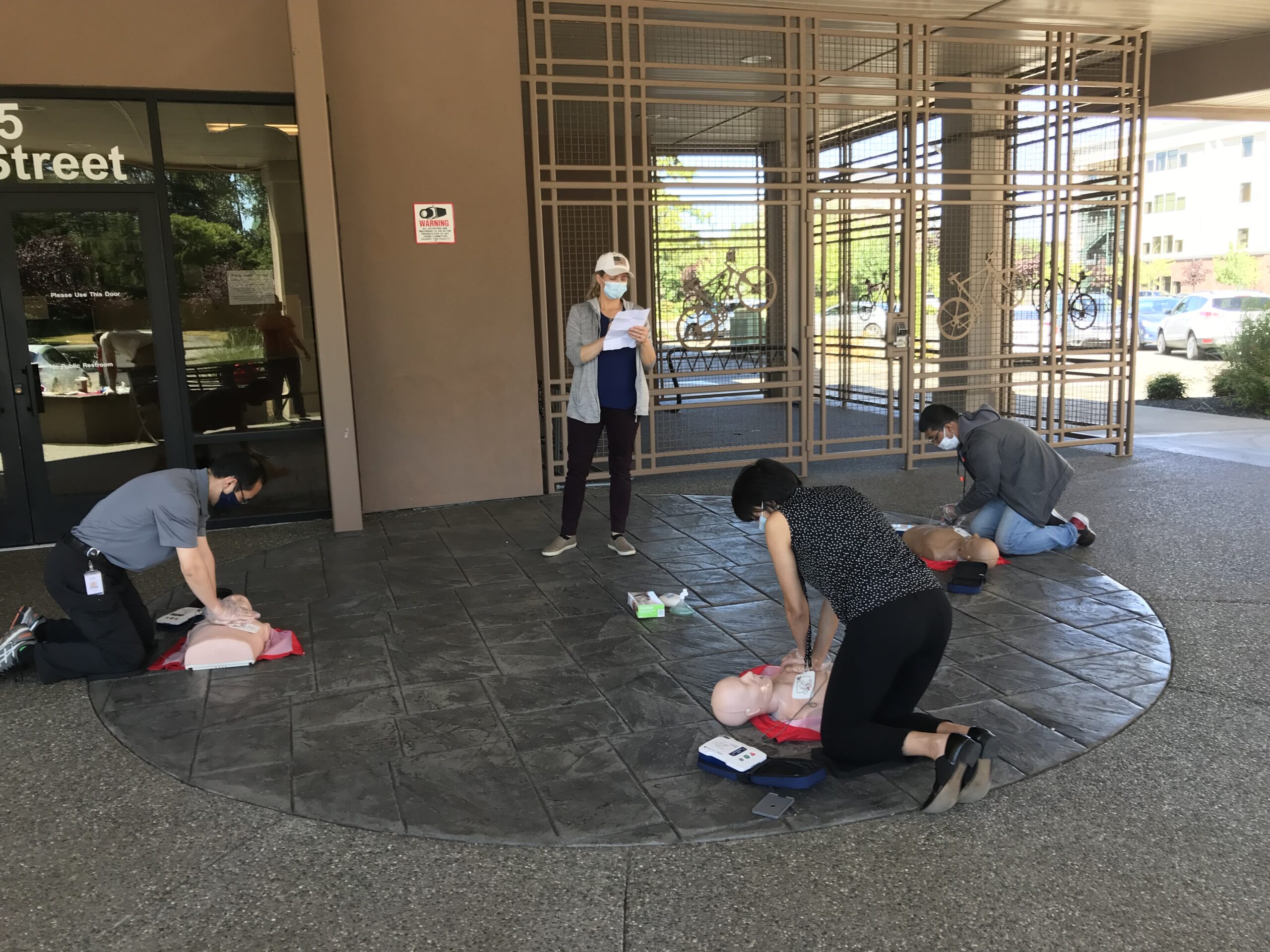 Office team completing workplace CPR training during onsite session