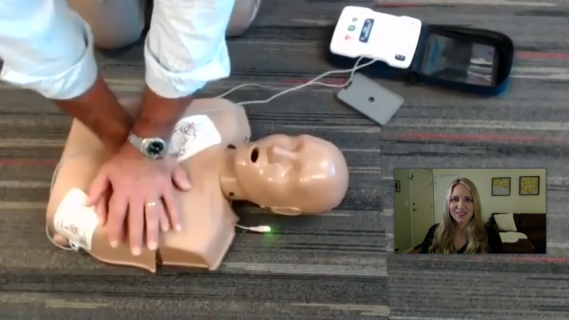 Instructor leading CPR training with manikin in Seattle classroom